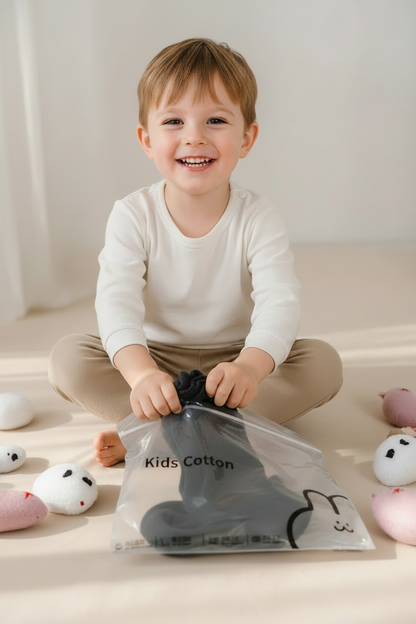 Package of kids cotton with small plush toys in the background