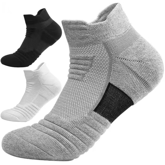 Three pairs of socks in black, gray, and white on a white background